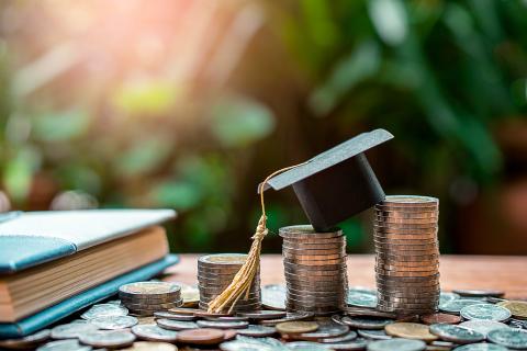 Graduation cap, book, and money