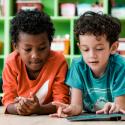 Two elementary students reading together